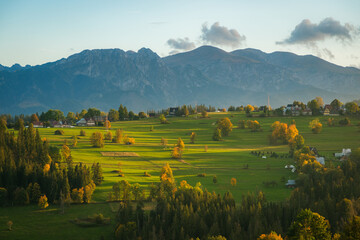 Views of rural farm fields and the Tatra Mountains from Suche, a village near Zakopane, Poland - obrazy, fototapety, plakaty