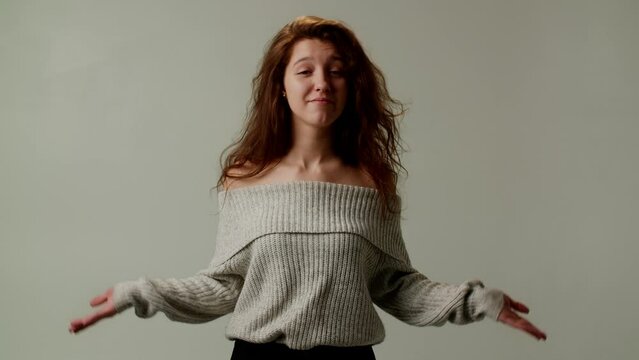 A young lady boss shows emotional coolness and unwillingness to bear responsibility for another blunder of a subordinate. Demonstration of closedness with crossed arms over chest. Gesture of spreading