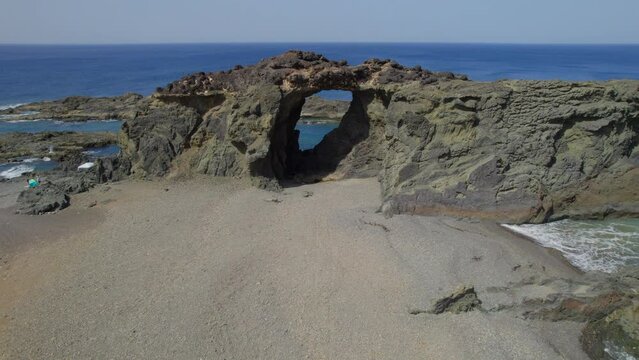 Fuerteventura Island, Ajui: aerial view traveling in over the Jurado arch on a sunny day with beautiful colors.