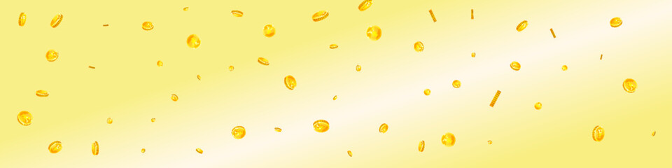 Chinese yuan coins falling. Scattered gold CNY