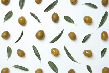 Olives with fresh leaves on a light background