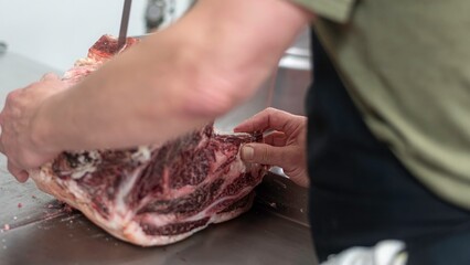 Isolated close up high resolution image of beef/ meat cutting and preparation process in a boutique...