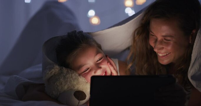 Night, mother and girl with a tablet, smile and digital app with connection, laugh and bonding with joy. Family, mama and child with technology, blanket and home with social media, relax and internet