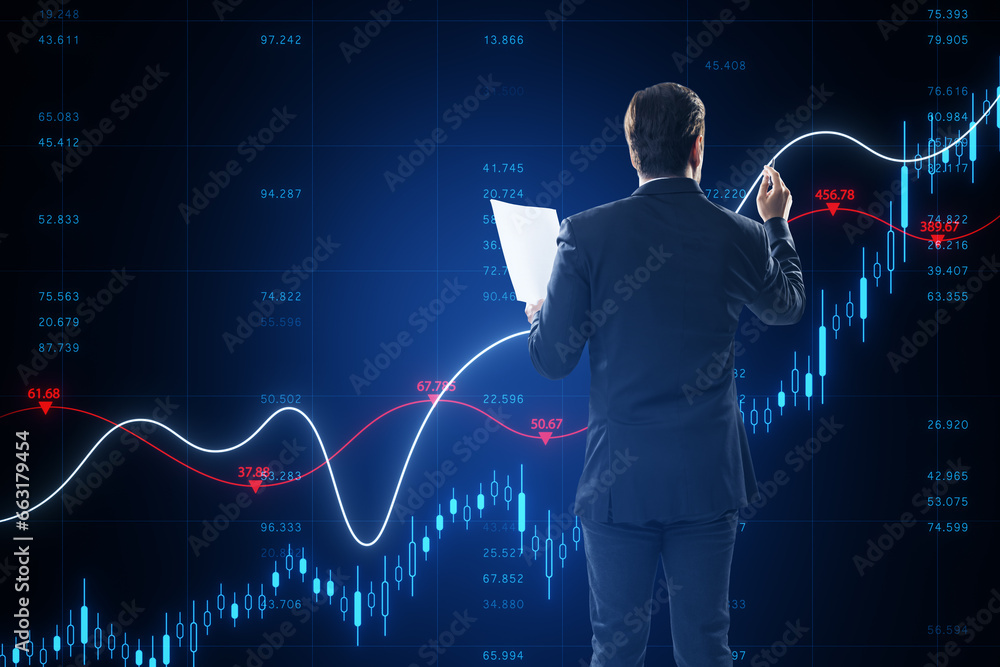 Aufkleber back view of attractive young businessman holding document and using growing blue forex chart and in