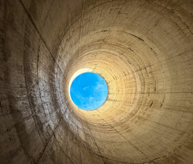 light at the end of the tunnel, concept. blue sky seen through a furnace hole. abandoned furnace.