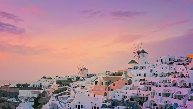 Sunset sky over Santorini island in Greece. Windmills of Oia town against sky