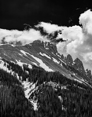 a black and white photo of a mountainous area with snow covered mountains