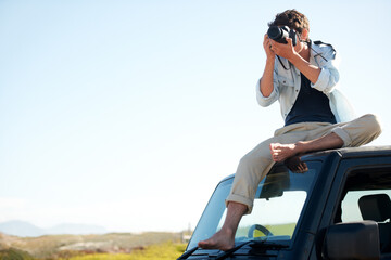 Man, photographer and camera on car with sky for road trip, adventure or journey on rooftop with travel. Person, photography or memories for vacation, holiday or scenery in Asia on mock up in nature