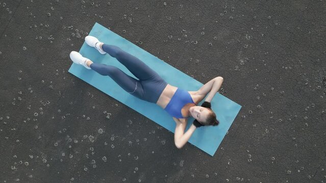 Top-down view of a fit woman doing cross-body crunches