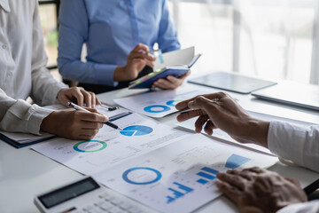 Investors, businessmen meeting to discuss stock statistics, summary graph analysis, business expense reports. and working information regarding the company's financial statements