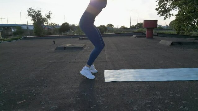 Fit woman does burpees in a tracking shot