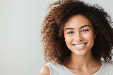 Face of beautiful mixed race woman smiling with white teeth, Portrait of a woman's face with brown eyes and freckles posing with copy-space, Dental health and oral hygien