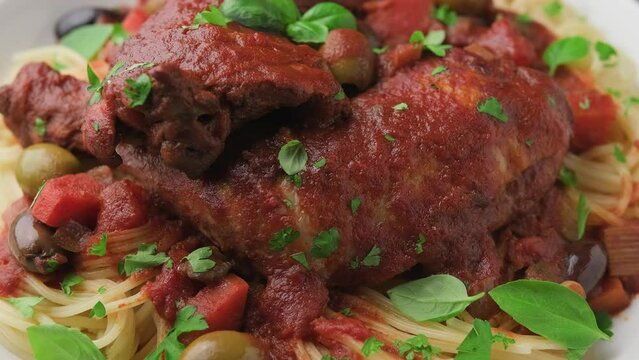 Cacciatore Chicken with spaghetti, vegetables, olives and tomatoes. Rotating video