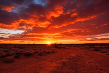 Fototapeta na wymiar fiery red and orange sunset over a desert