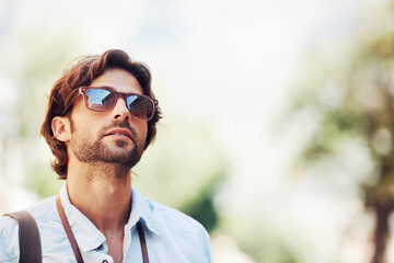 Travel, man or tourist on holiday, vacation or weekend trip for a fun adventure in Italy with sunglasses. Bokeh mockup space, view or person with fashion or freedom sightseeing in nature journey