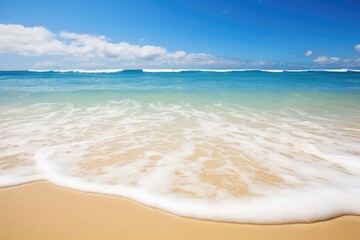 Fototapeta na wymiar ocean waves lapping a clean sandy beach
