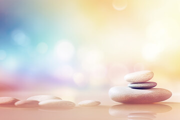 Obraz na płótnie Canvas Harmony of nature, healing, spa relaxing and mental health background. Massage stones on tender blurred background, symbolizing tranquility and unity with nature. Template, copy space