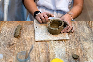 Ceramic Workshop. Close-up of a woman's hands working with clay.