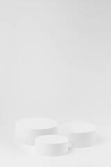 Abstract white scene with three round podiums mockup. Template for presentation cosmetic products, goods, advertising, design, sale, text, display, showing in minimalism style.