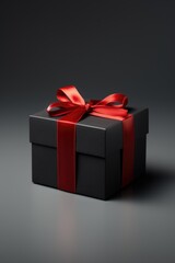 Black gift box with red ribbon bow on dark background. shopping.
