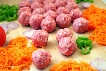 Raw Pork Meatballs and Fresh Vegetables - Ingredients for Spanish Tapas