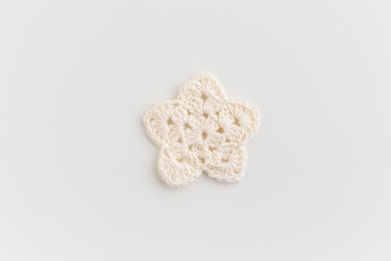 The white crocheted star pattern on a white background.