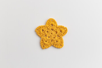 The yellow crocheted star pattern on a white background.