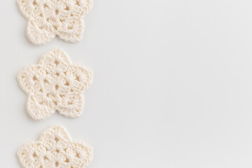 White crocheted stars row pattern on a white background. - obrazy, fototapety, plakaty