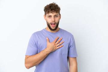 Young handsome caucasian man isolated on white background surprised and shocked while looking right