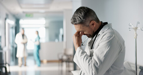 Naklejka na ściany i meble Stress, grief or fail with a mature doctor in a hospital looking unhappy for healthcare or medical. Depression, mistake or loss with a sad man medicine professional in a professional medicare clinic