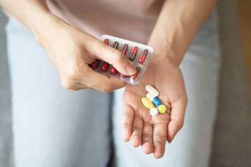 Healthcare Harmony: Close-Up Hands Holding Medication and Water Glass for Optimal Wellness,...