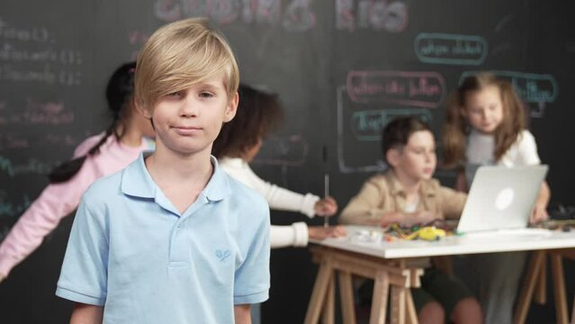 The young boy at coding and programming classroom at school