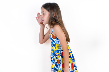 Half-faced close up portrait of astonished amazed Beautiful little kid girl wearing colorful dress...