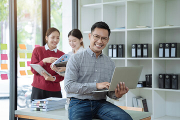 Happy smiling businessman feel happy work complete Teamwork success, success at work in the office concept.