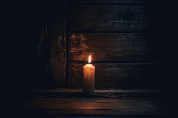 a dark room lit only by a flickering candle