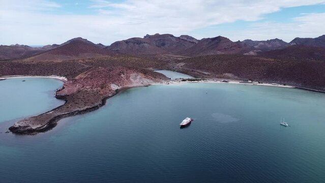 Aerial wide view of the beautiful Playa Pichilingue near Pichilingue port of La paz in Baja California Sur Mexico with blue sea with floating ships and rocky landscape