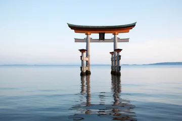 Poster Im Rahmen shinto gate torii standing at the edge of a calm sea © altitudevisual