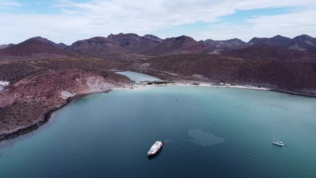 Aerial view of Playa Pichilingue, Pichilingue Ferry and Cruise Port Near La Paz, Baja California Sur, Mexico with Pristine Beach, Stunning Coastline and Majestic Mountains in the Background
