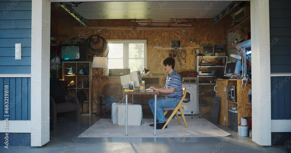 Aufkleber Caucasian Male Software Developer Programming On Old Desktop Computer In Retro Garage With Random Appliances. Man Working On Innovative Fintech Startup Company In Nineties. Nostalgia Concept.