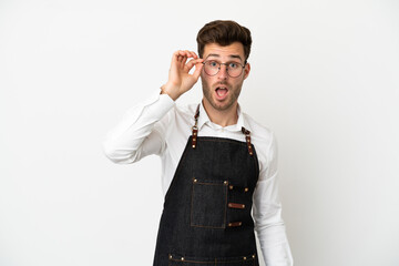 Fototapeta premium Restaurant caucasian waiter isolated on white background with glasses and surprised