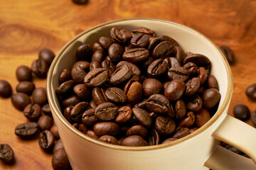 Black coffee and coffee beans on Wooden table