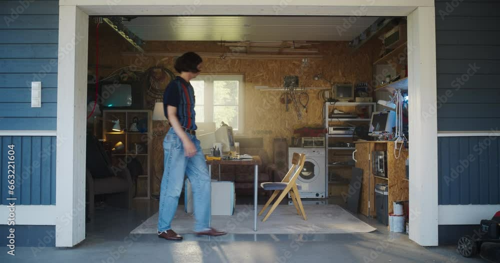 Leinwandbilder caucasian man opening garage door and sitting behind old desktop computer in retro garage. male e-co
