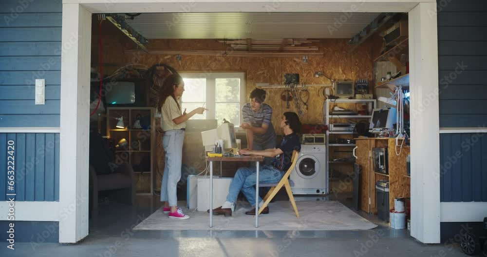 Poster diverse team of three young startup company founders working in retro garage, using old desktop comp