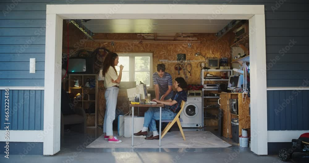 Leinwandbilder diverse team of three young startup company founders working in retro garage, using old desktop comp