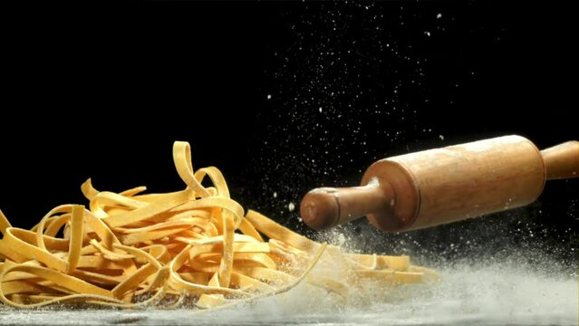 The rolling pin falls on the table with flour. Filmed on a high-speed camera at 1000 fps. High quality FullHD footage