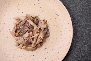 Delicious spicy mushrooms sliced and cooked in Korean style on a ceramic plate