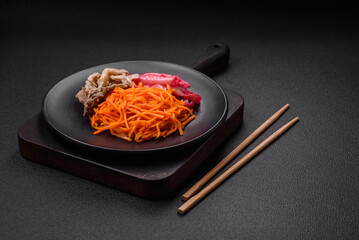 Delicious spicy mushrooms, carrots, cabbage sliced and cooked in Korean style