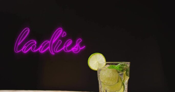 Animation of ladies neon text and cocktail on black background