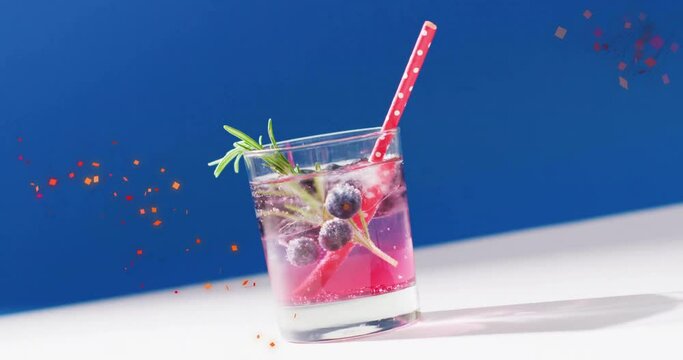 Animation of confetti falling and cocktail on blue background