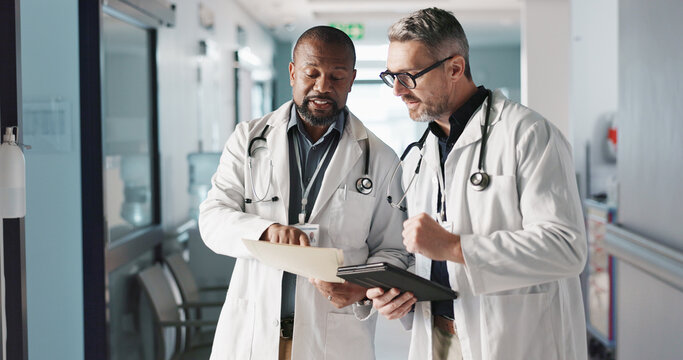 Doctors, teamwork and advice with documents, hospital folder and patient charts for healthcare planning or solution. Professional men with file, digital tablet and medical information or clinic data